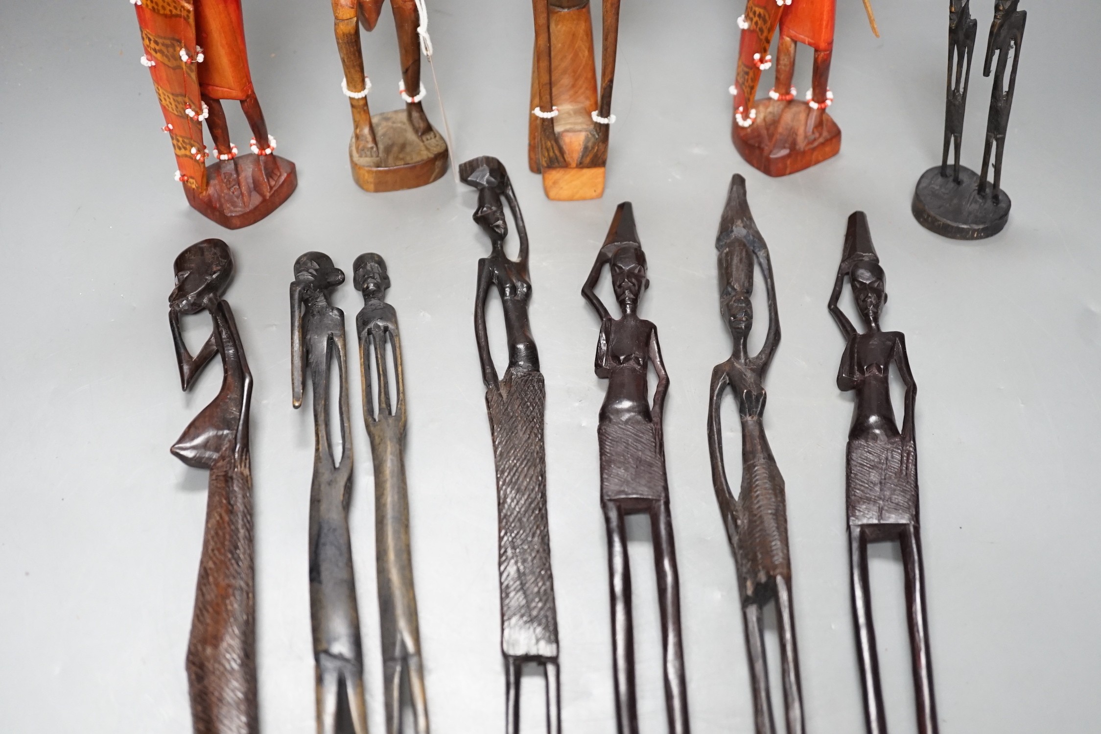 12 African carved wood stick figures, tallest 38cms high